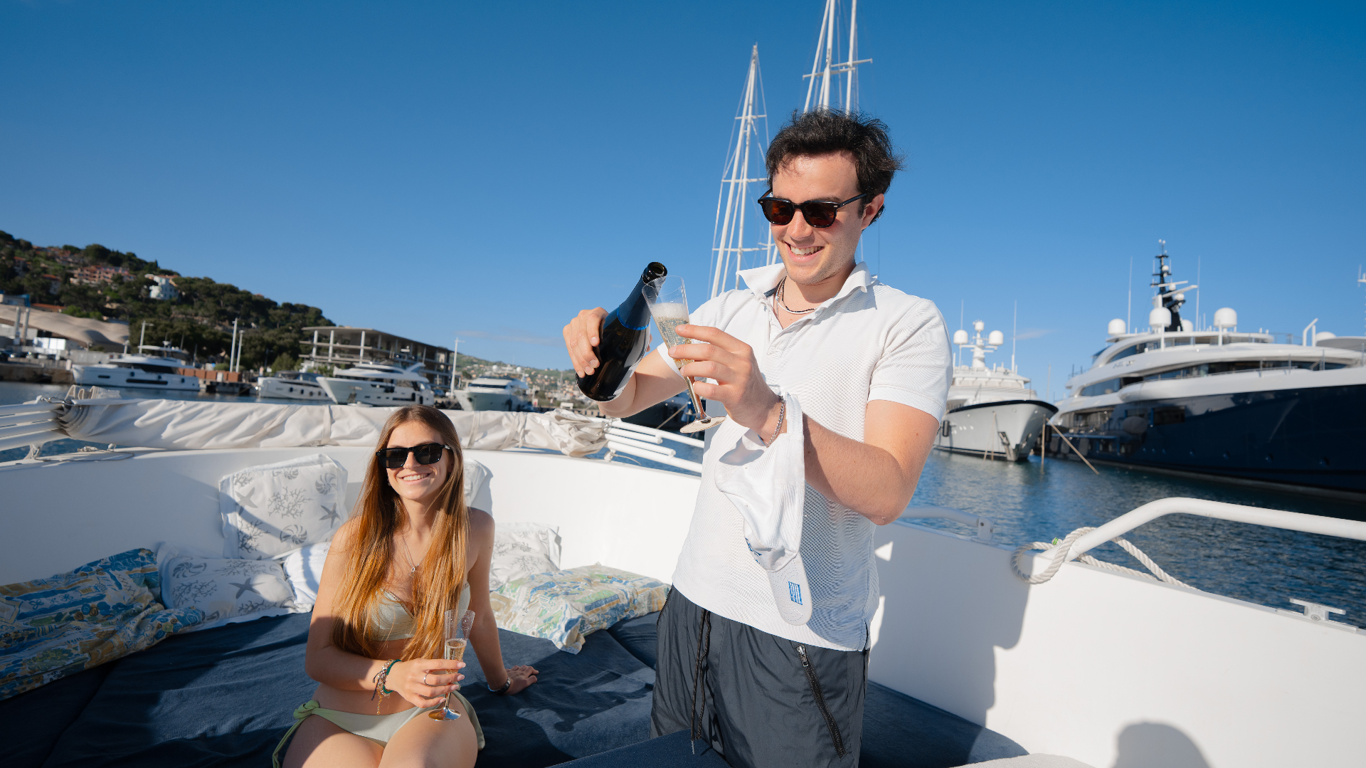 Pouring prosecco on deck under the Ligurian sun